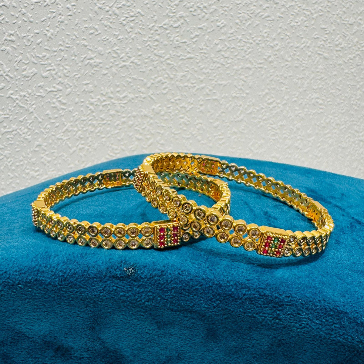 Elegant ad stone and red diamond and green stone golden bangels