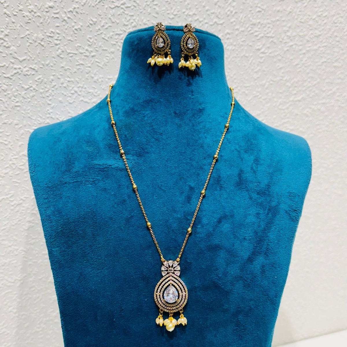 Posh crystal stone with ad stone and pearls golden chain necklace