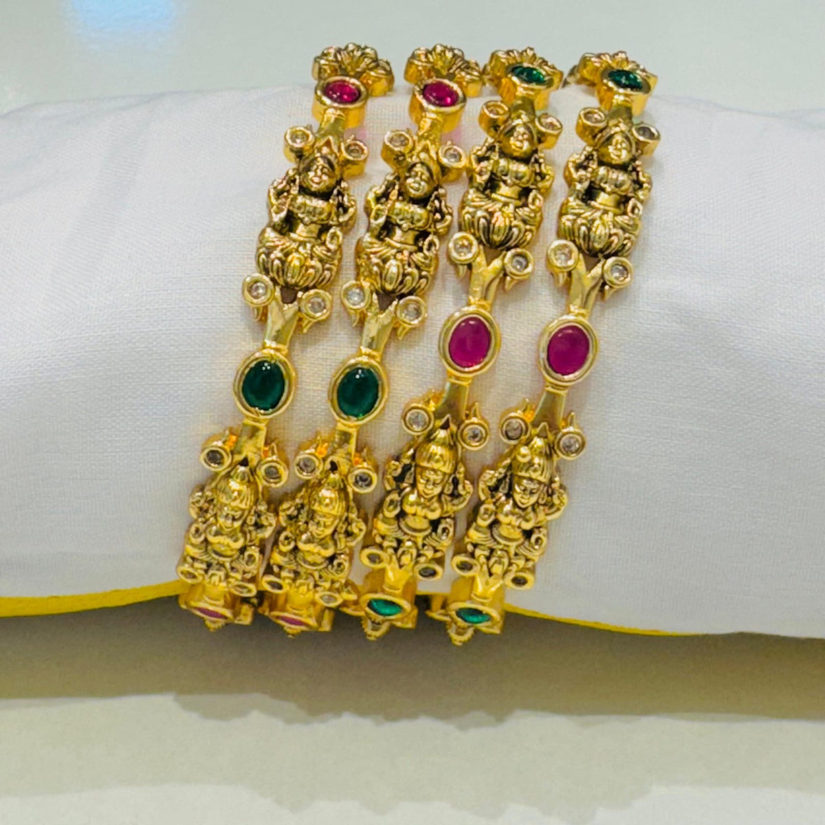 Captivating laxmi design with red and green stone golden bangels