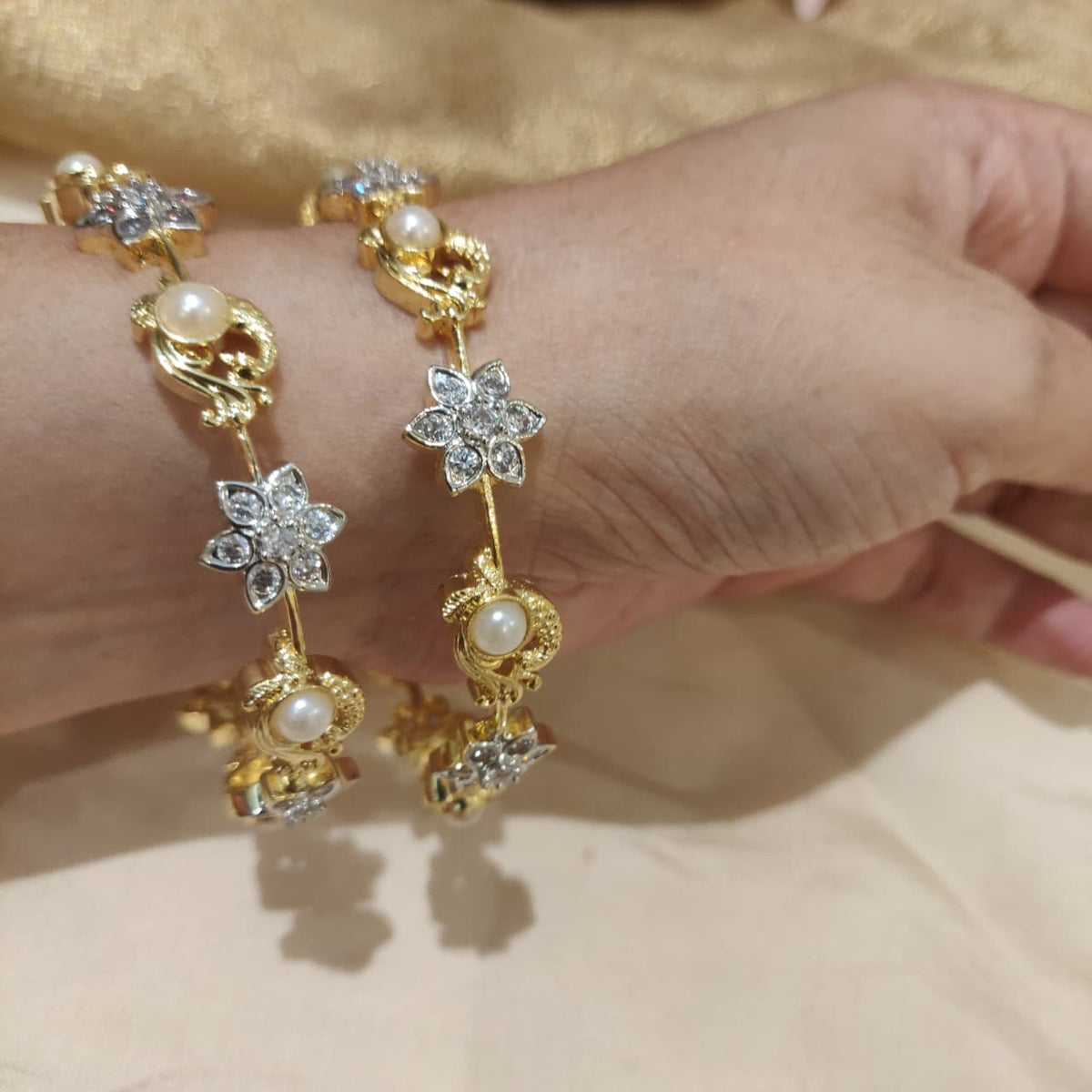 Majestic golden cz floral pearl bangles set of 2