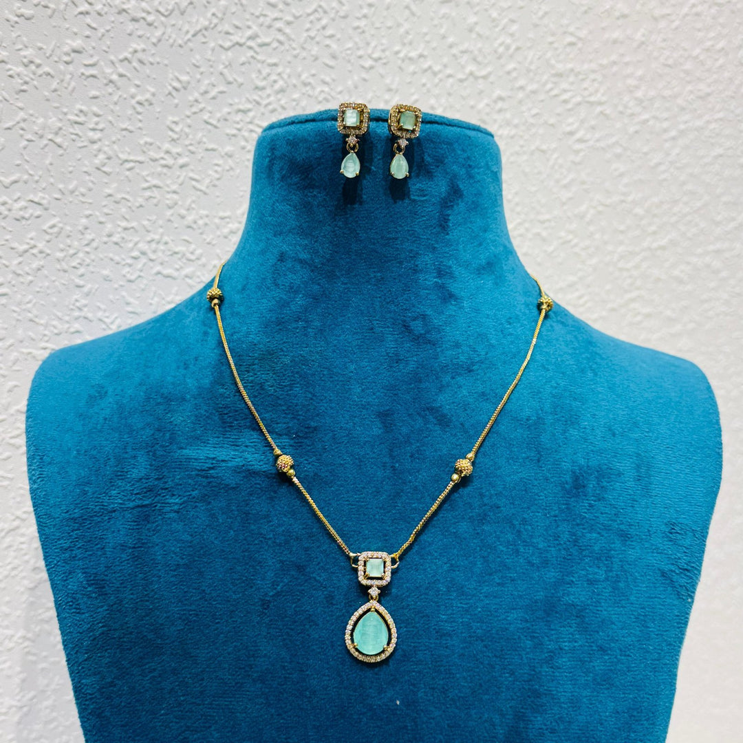 Lustrous Sparkling sky blue stone  and ad stone and golden chain necklace