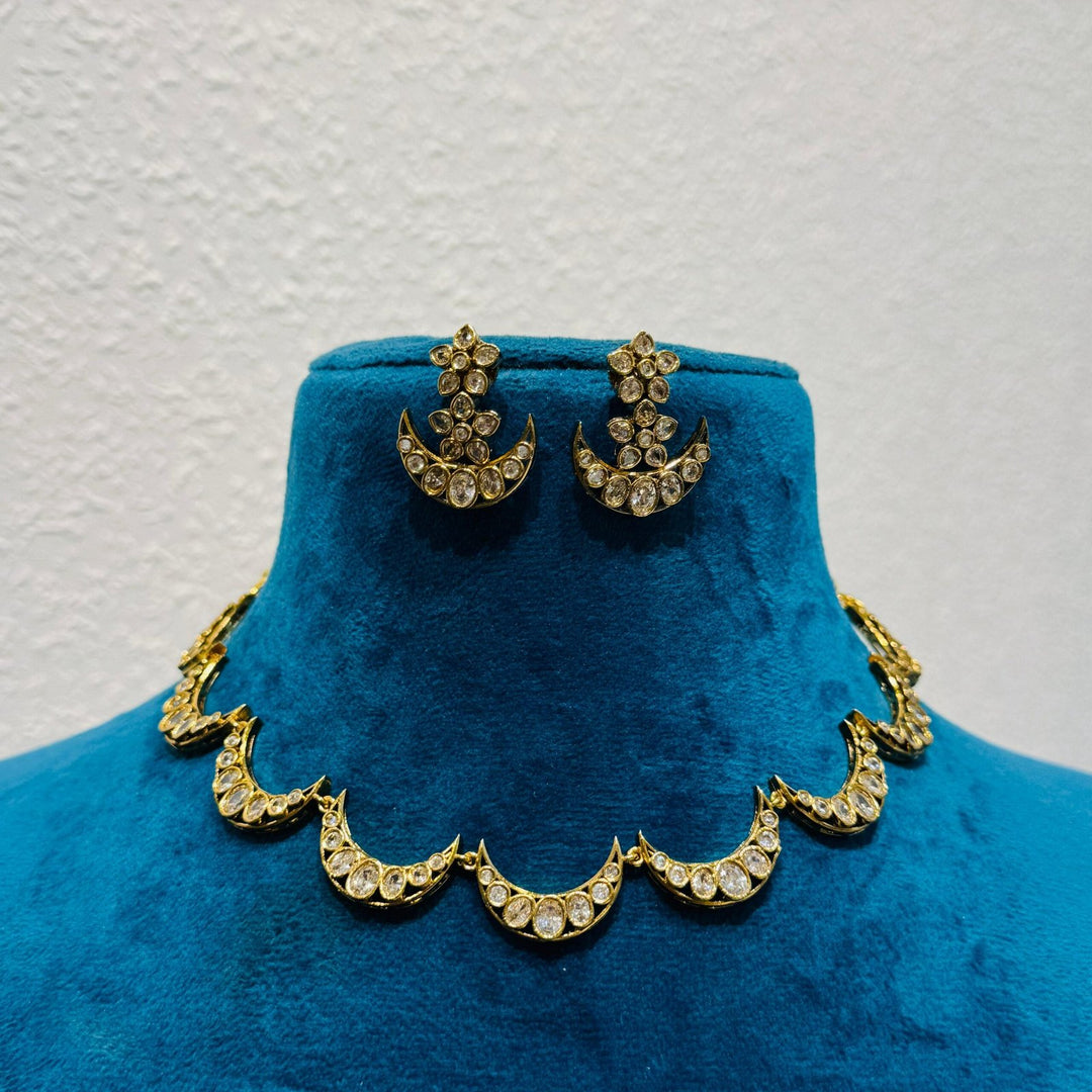 Enigmatic half moon ad stone golden choker necklace