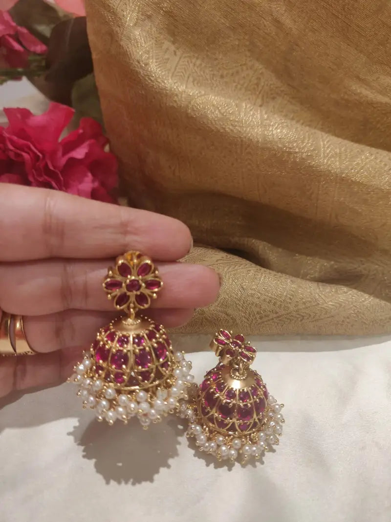 Exotic pink meenakari art styled gold finish jhumka earrings