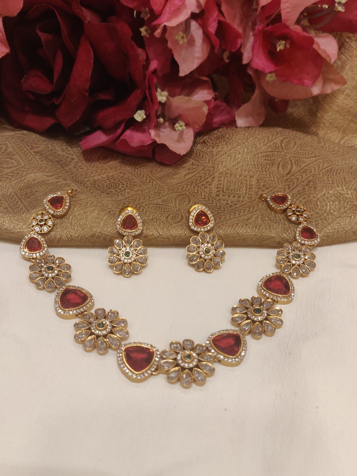 Majestic gold plated floral design red stone styled short necklace cz
